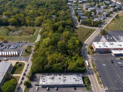 an aerial view of a house with a garden and lake view