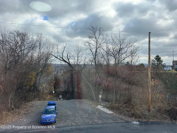 a view of a pathway with a wrought fence