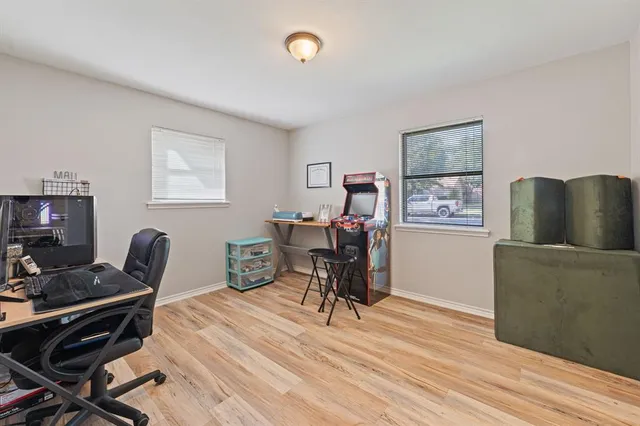 a view of a workspace with furniture and a window