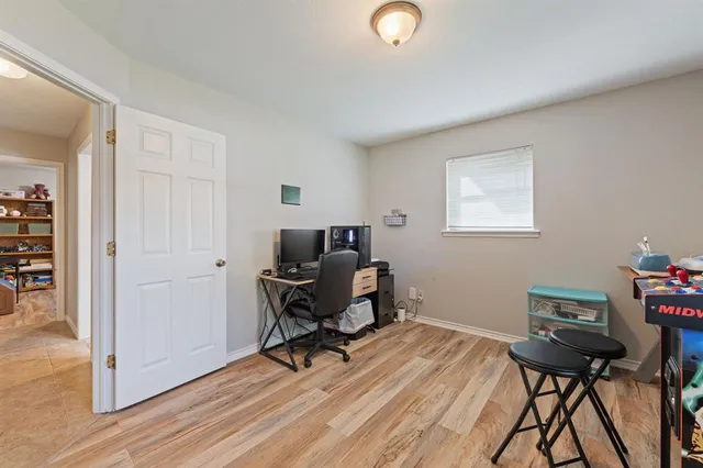 a view of a workspace with furniture and a window