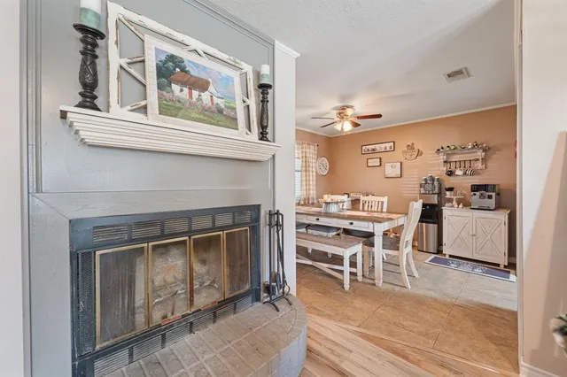a living room with stainless steel appliances kitchen island granite countertop furniture and a fireplace