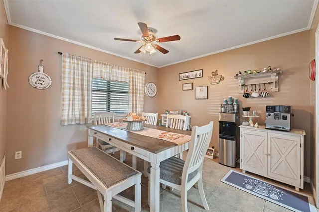 a view of a dining room with furniture and a chandelier