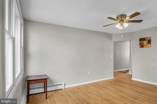 a view of room with window and wooden floor