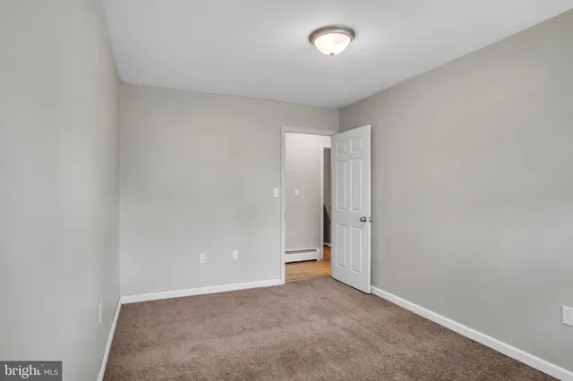 an empty room with windows and gate