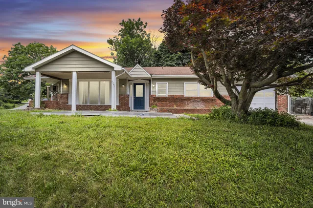 a front view of house with yard and green space