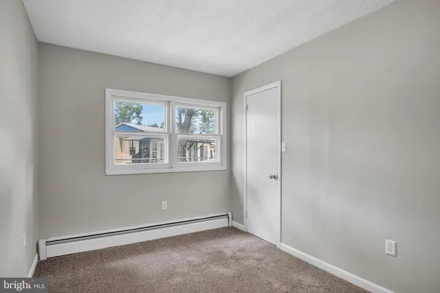 a bedroom with a bed and a mirror