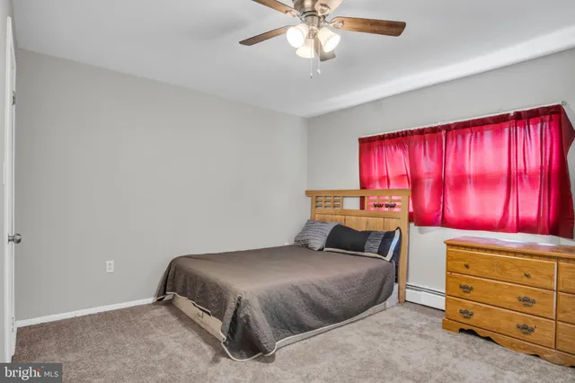 a bathroom with a toilet a sink and a window