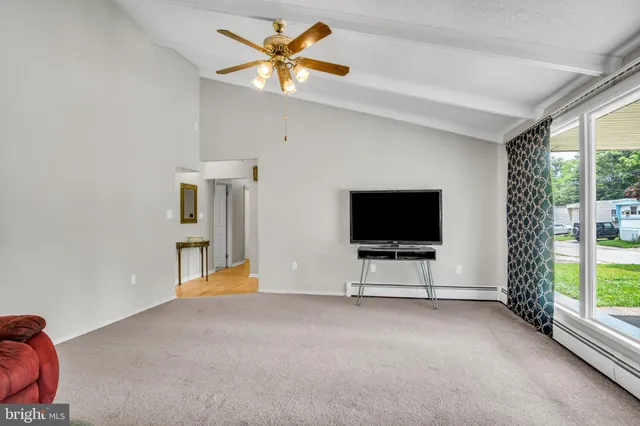 a view of a livingroom with furniture and a flat screen tv