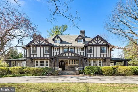 a front view of a house with swimming pool and outdoor seating