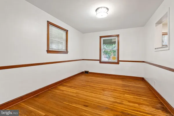 a view of a room with window and wooden floor