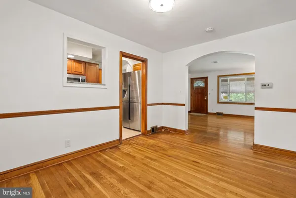 a view of a room with wooden floor and a window