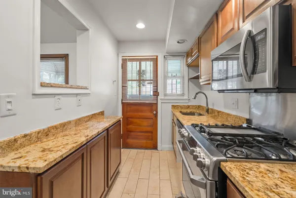 a kitchen with stainless steel appliances granite countertop a stove and a sink
