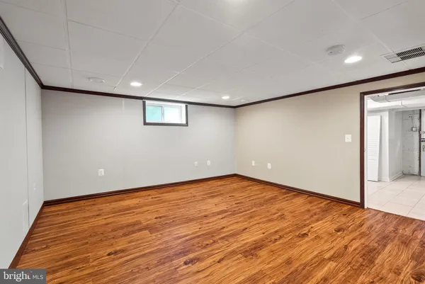 a view of an empty room with wooden floor