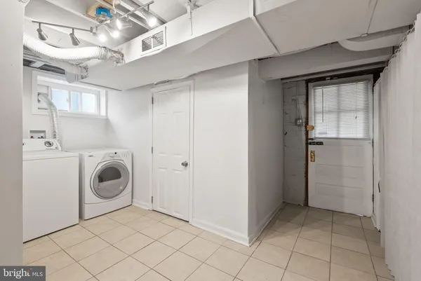 a view of a storage & utility room with washer and dryer