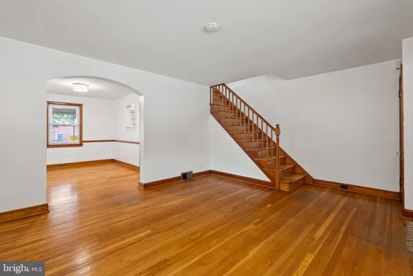 a view of an empty room with wooden floor