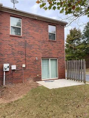 a view of a brick house with large windows