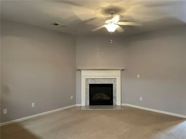 a view of an empty room with a fireplace