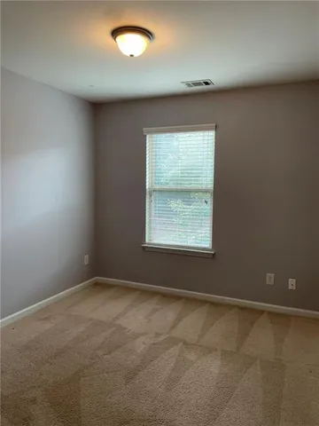 an empty room with a empty space and windows