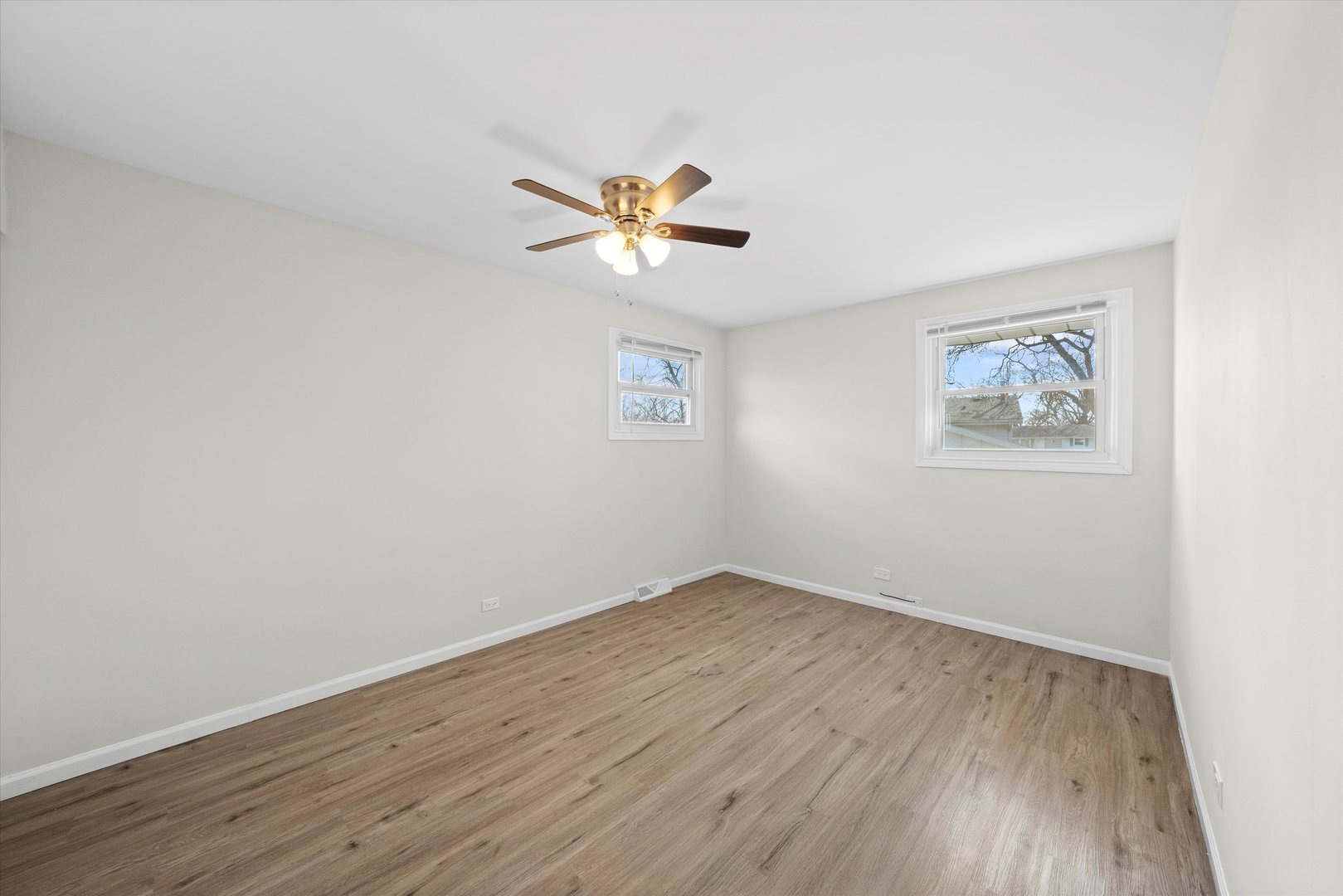 3508 Maple Lane Hazel Crest, IL 60429 - Photo 16 of 34 an empty room with wooden floor and a ceiling fan