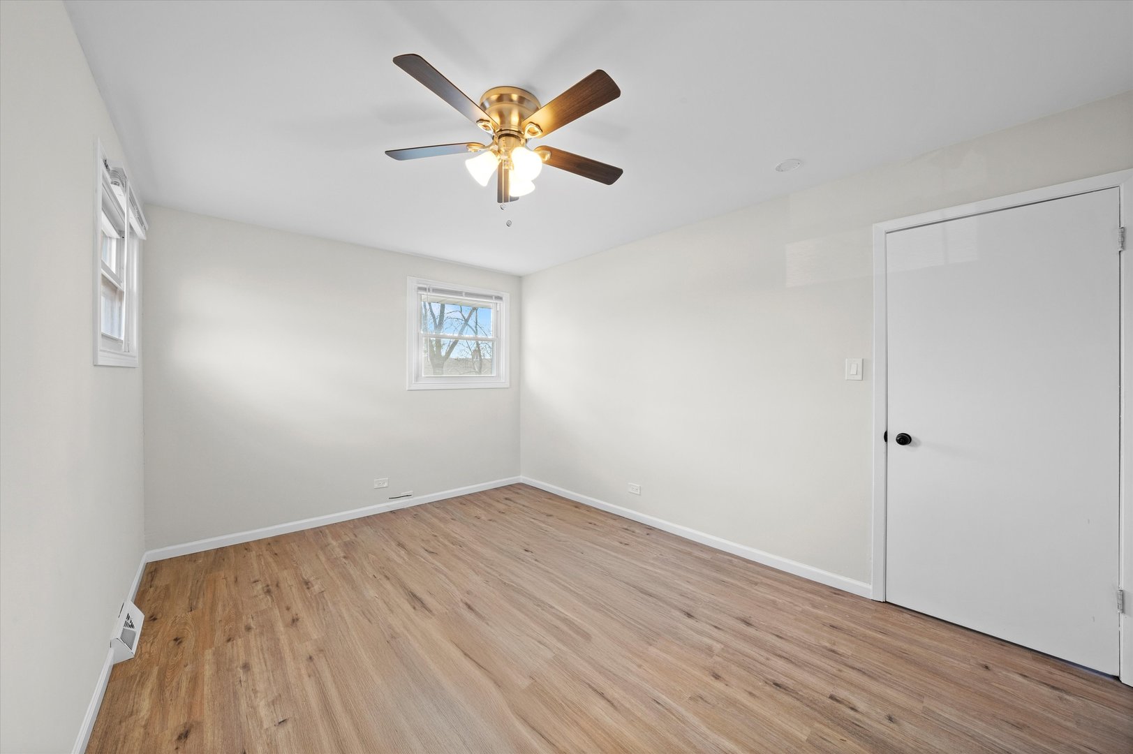 3508 Maple Lane Hazel Crest, IL 60429 - Photo 17 of 34 an empty room with wooden floor and windows