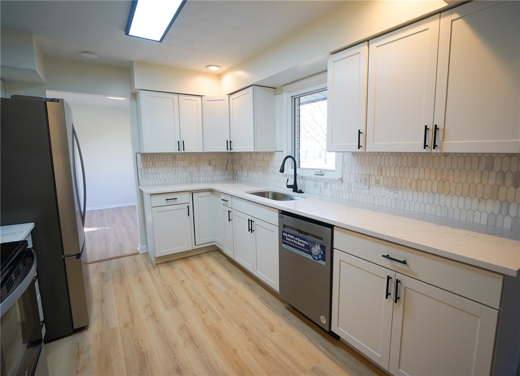 8746 Grubbs-Rex Road Arcanum, OH 45304 - Photo 33 of 38 This modern kitchen features crisp cabinetry, sleek countertops, and contemporary appliances for everyday living.