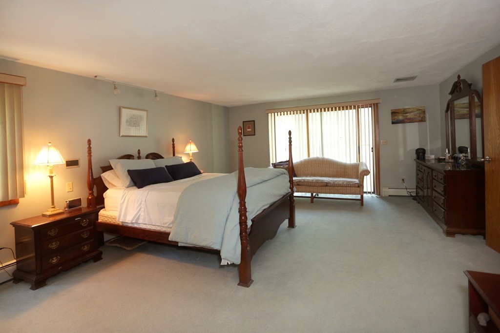 63 Porter Road Boxford, MA 01921 - Photo 11 of 30 a spacious bedroom with a bed and a couch