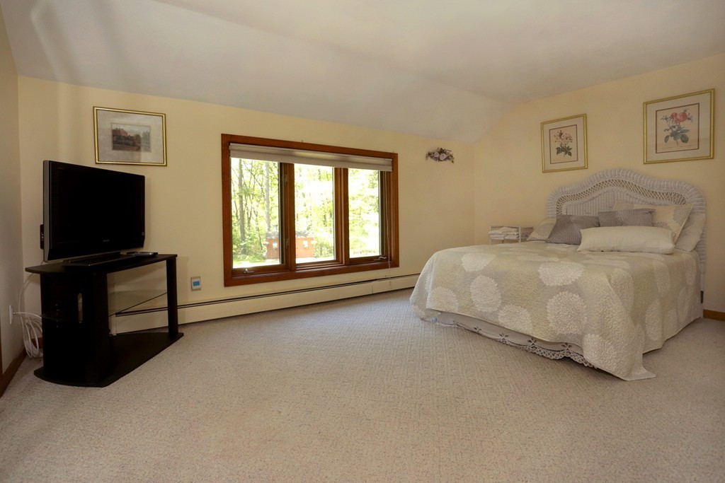 63 Porter Road Boxford, MA 01921 - Photo 12 of 30 a living room with a bed furniture and a flat screen tv