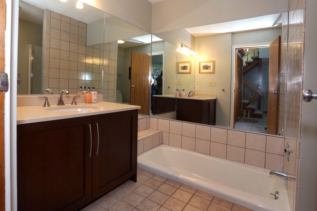 63 Porter Road Boxford, MA 01921 - Photo 16 of 30 a bathroom with a bathtub a sink and a mirror