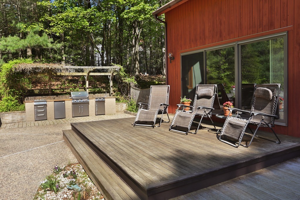 63 Porter Road Boxford, MA 01921 - Photo 19 of 30 a view of a patio with table and chairs and wooden floor