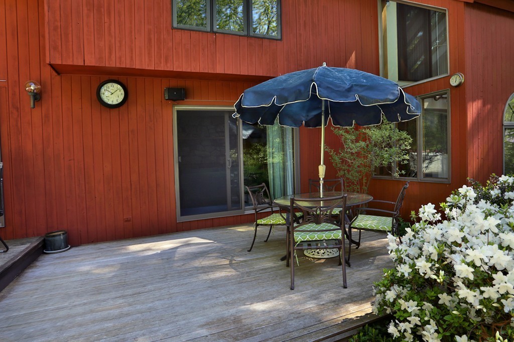 63 Porter Road Boxford, MA 01921 - Photo 22 of 30 a view of a house with backyard sitting area and garden
