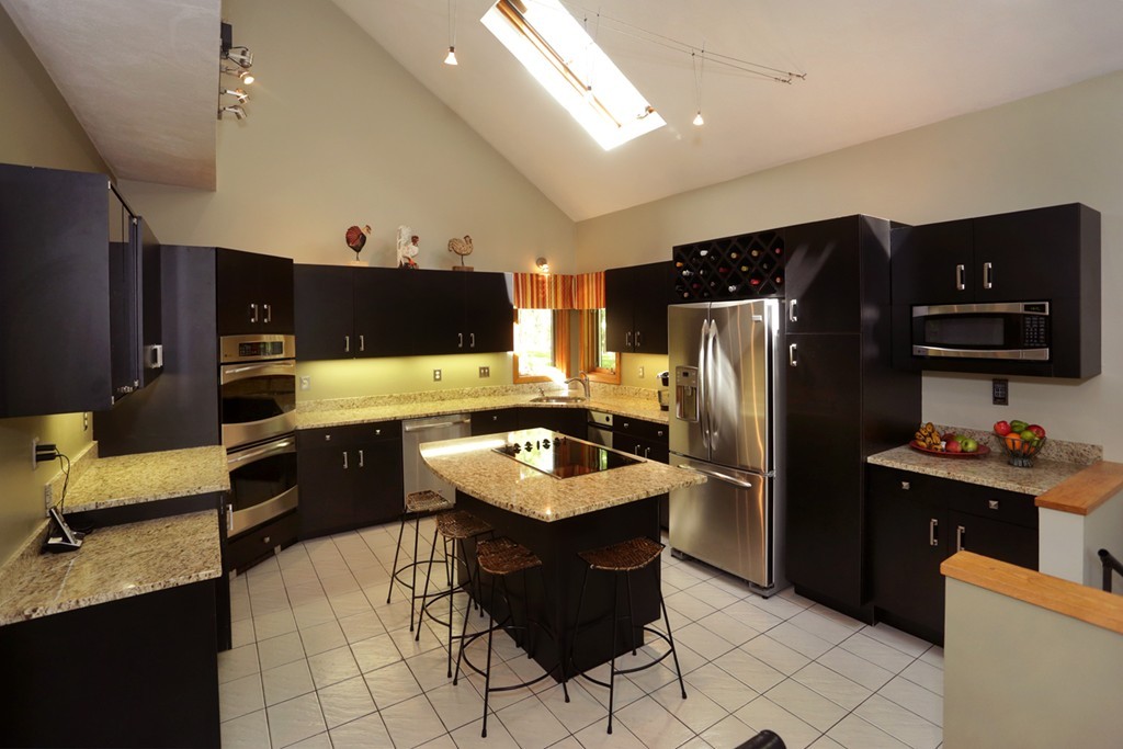 63 Porter Road Boxford, MA 01921 - Photo 3 of 30 a kitchen with stainless steel appliances granite countertop a refrigerator a stove a sink and a microwave