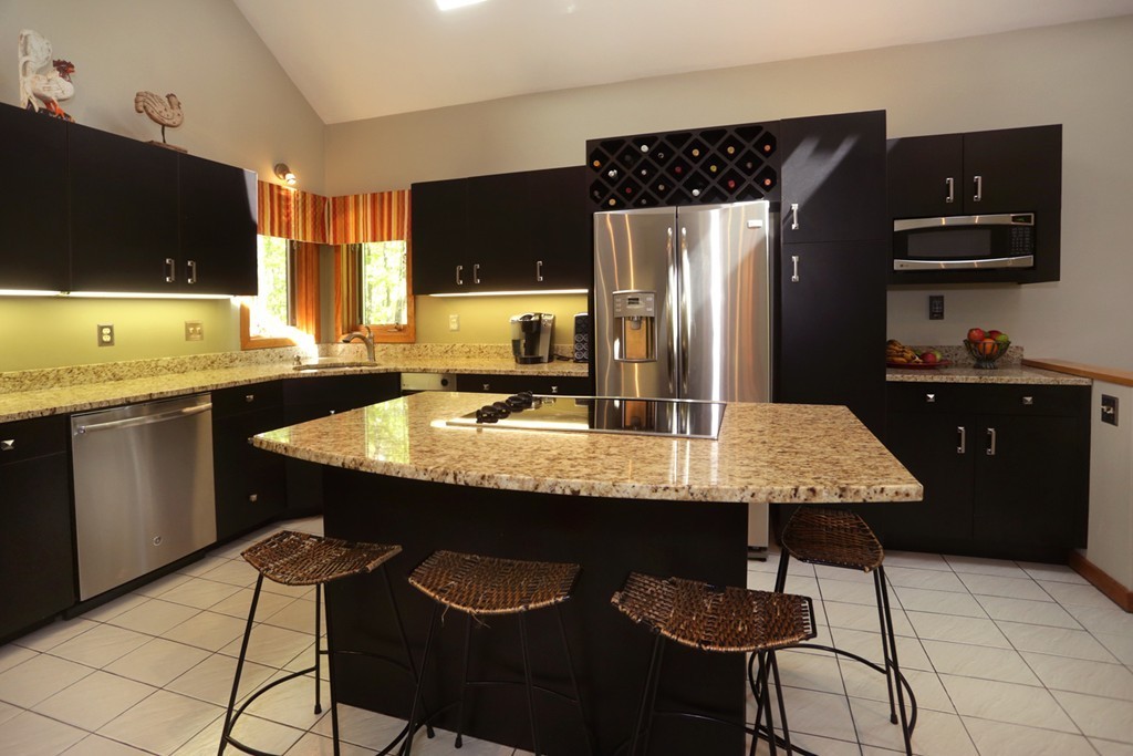 63 Porter Road Boxford, MA 01921 - Photo 4 of 30 a kitchen with granite countertop a sink a stove a refrigerator and cabinets