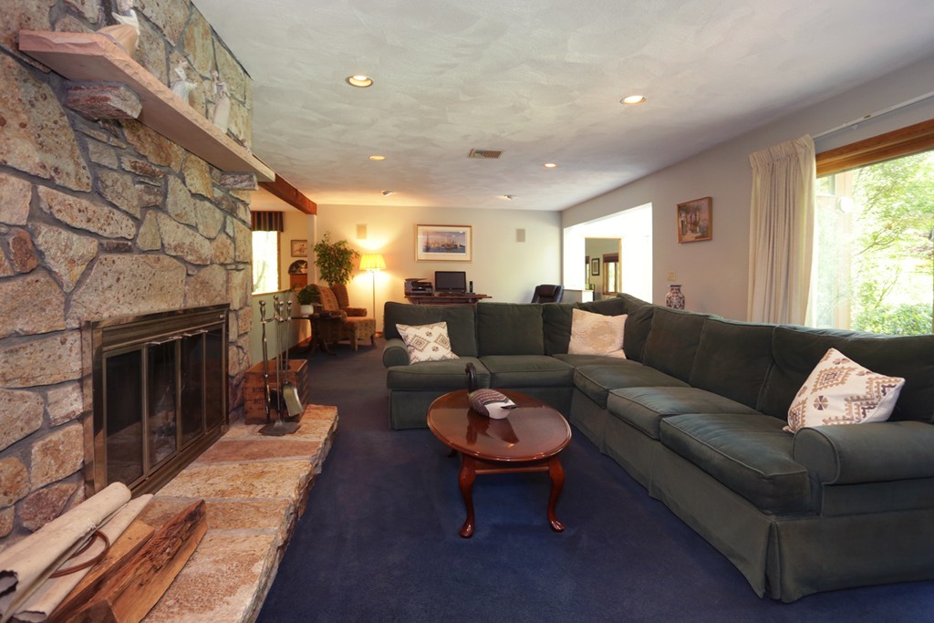 63 Porter Road Boxford, MA 01921 - Photo 8 of 30 a living room with furniture a fireplace and a table