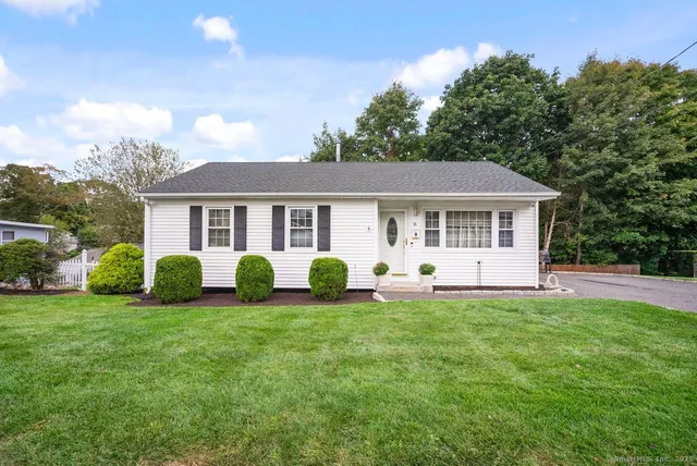 a view of a house with a backyard