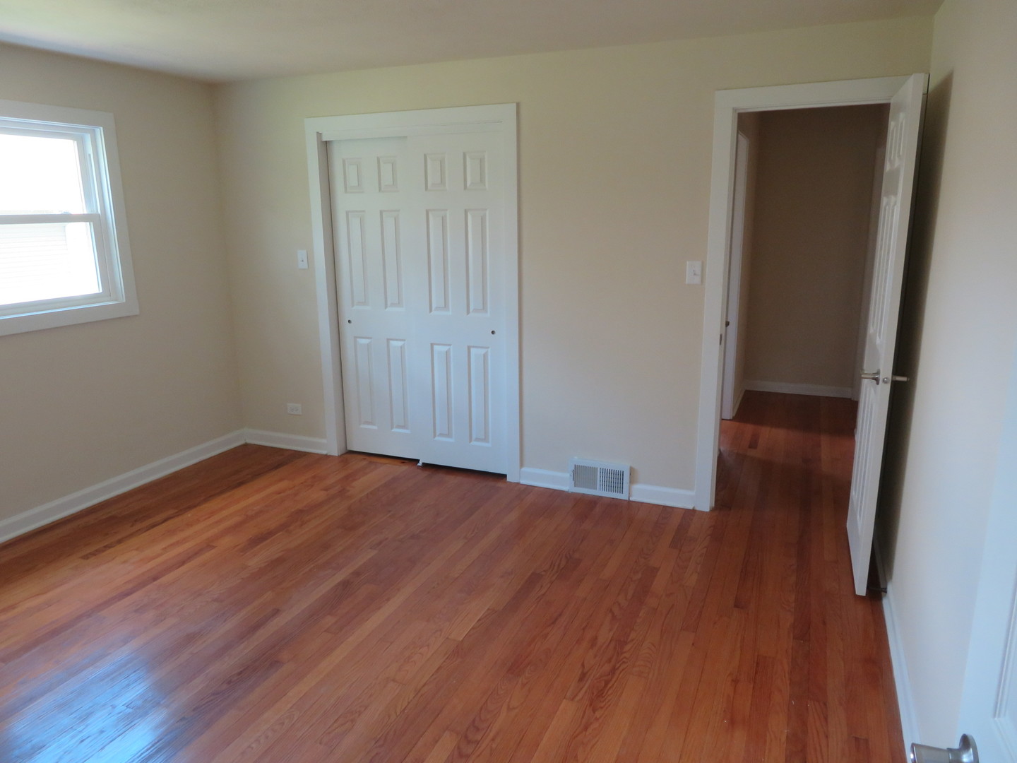 N336 Pleasant Hill Road Wheaton, IL 60187 - Photo 8 of 13 an empty room with wooden floor and windows