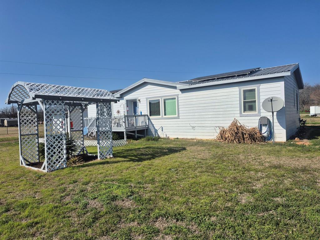 438 Silver River Road Gholson, TX 76705 - Photo 2 of 39 a front view of a house with garden
