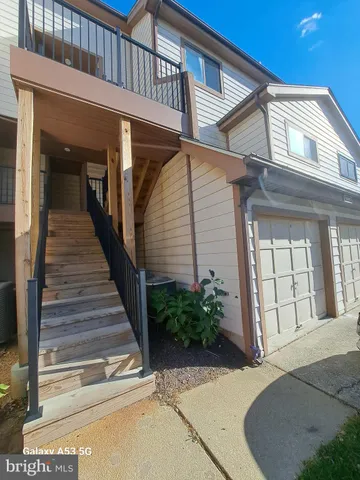 a view of a house with entryway and plants