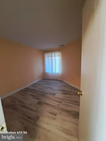 a view of an empty room and wooden floor