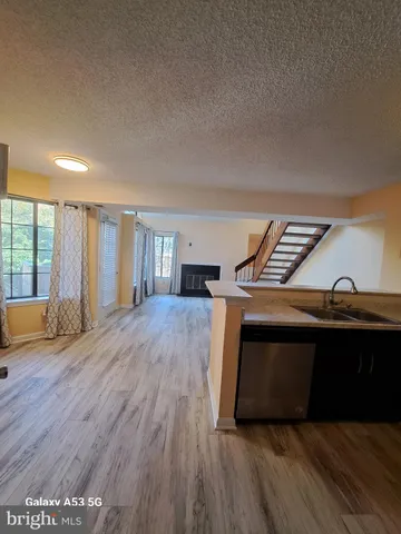 a kitchen with stainless steel appliances a refrigerator a stove a sink and a microwave