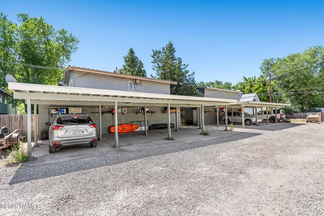 a view of a house with a small yard and wooden fence