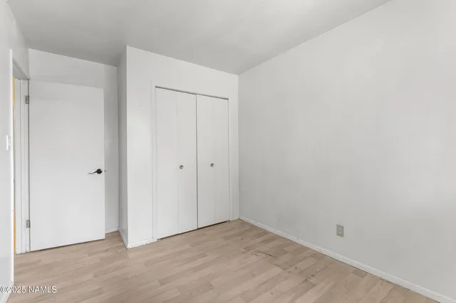 an empty room with wooden floor