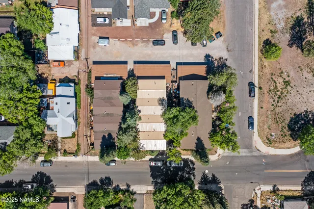 an aerial view of a house with a yard