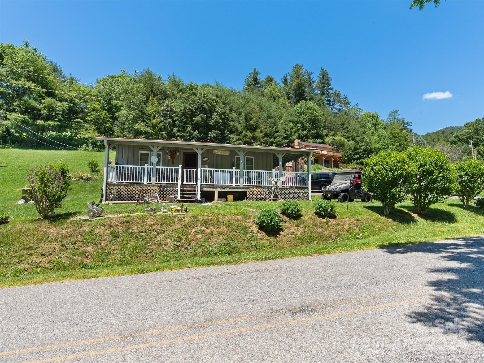 165 Van Arrington Road Clyde, NC 28721 - Photo 1 of 17 a house view with a garden space