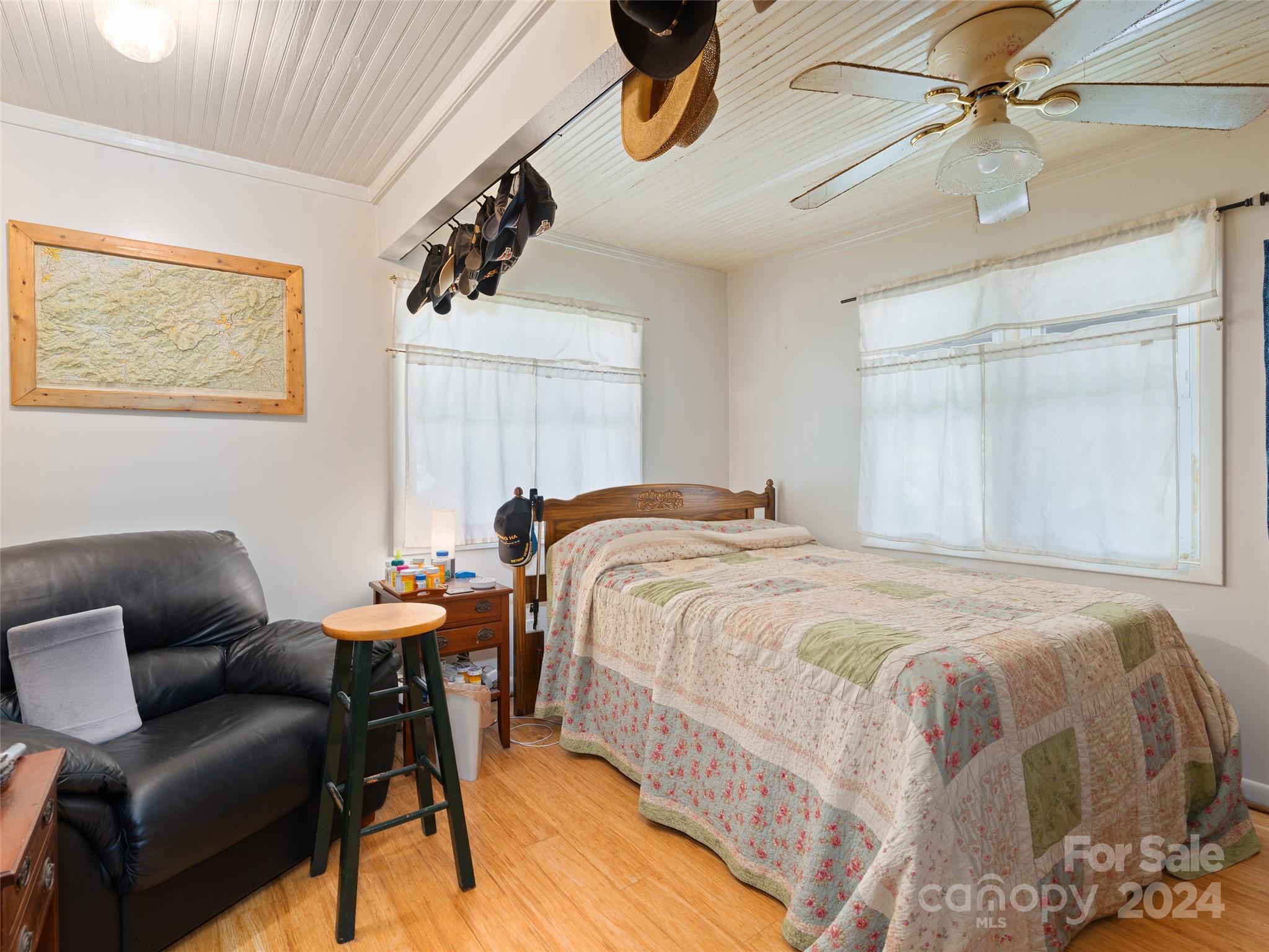 165 Van Arrington Road Clyde, NC 28721 - Photo 13 of 17 a bedroom with a bed and a chandelier