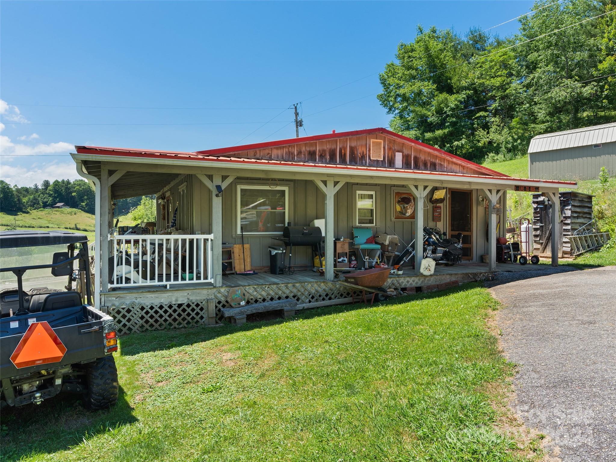 165 Van Arrington Road Clyde, NC 28721 - Photo 2 of 17 a view of a house with a porch and a patio