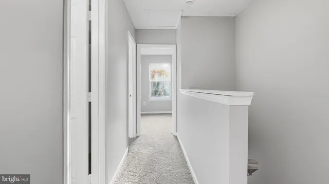 an empty room with closet and a bathroom