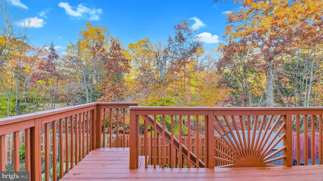 a view of a balcony with wooden fence and floor