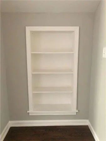 a view of a room with wooden floor