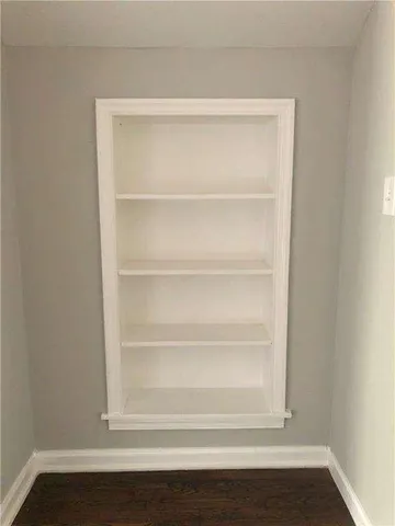 a view of a room with wooden floor