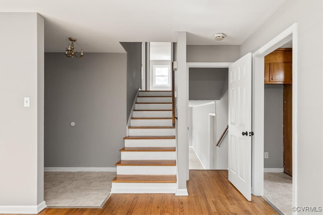 7801 Bull Hill Road Prince George, VA 23875 - Photo 11 of 49 Stairs featuring wood finished floors and a chande